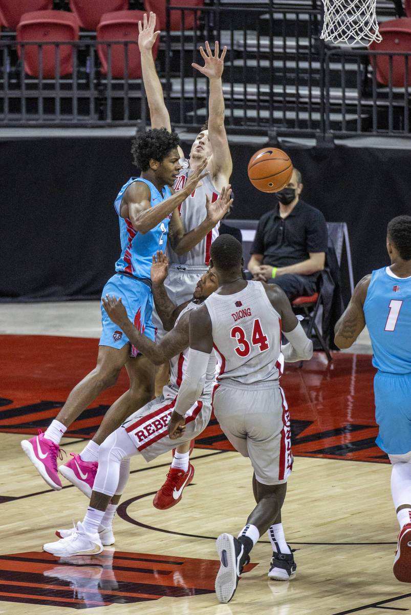 New Mexico Lobos guard Saquan Singleton (2) collides into UNLV Rebels forward Moses Wood (1)wit ...