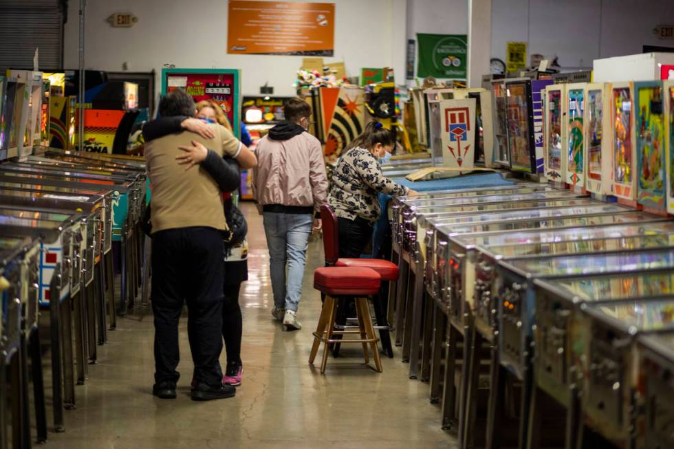 Individuals are seen in the Pinball Hall of Fame during the launch of a weekly food truck gath ...