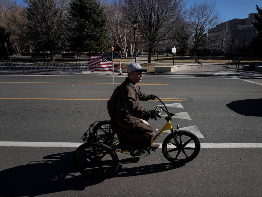 A bicyclist passes by the state Capitol complex on Sunday, Jan. 17, 2021, in Carson City, Nev. ...