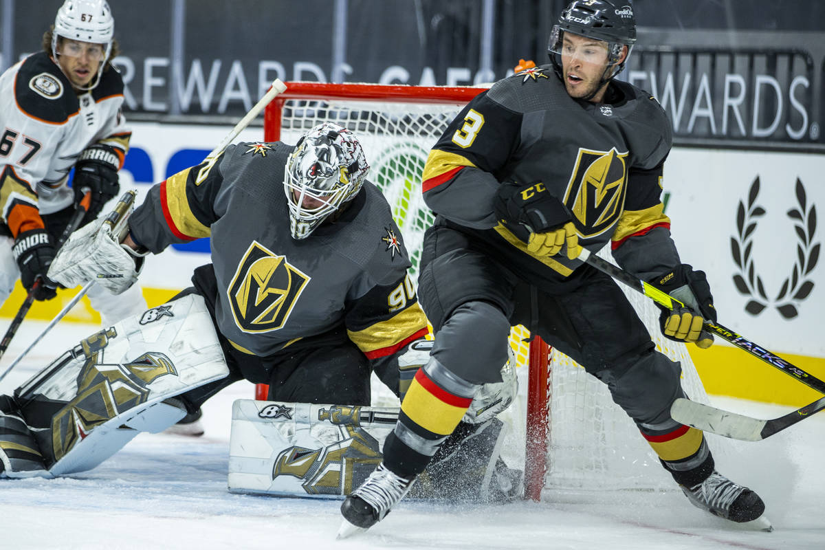 Golden Knights goaltender Robin Lehner (90) looks to block a shot with teammate defenseman Bray ...