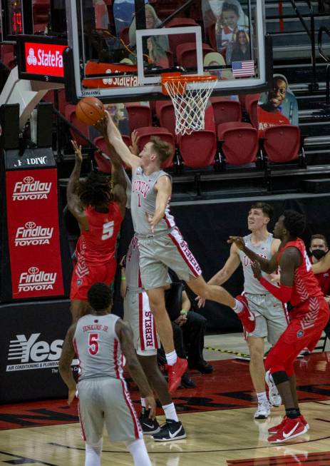 UNLV Rebels forward Moses Wood (1) blocks a shot from New Mexico Lobos forward Rod Brown (5) du ...