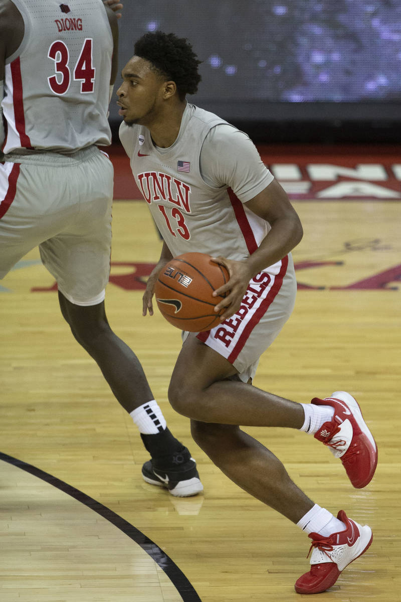 UNLV Rebels guard Bryce Hamilton (13) dribbles the basketball against the against the New Mexic ...