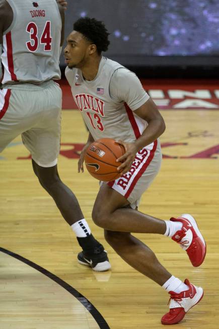 UNLV Rebels guard Bryce Hamilton (13) dribbles the basketball against the against the New Mexic ...