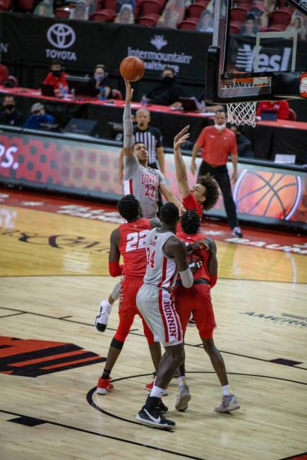 UNLV Rebels guard Nick Blake (22) makes a jump shot as New Mexico Lobos forward Valdir Manuel ( ...