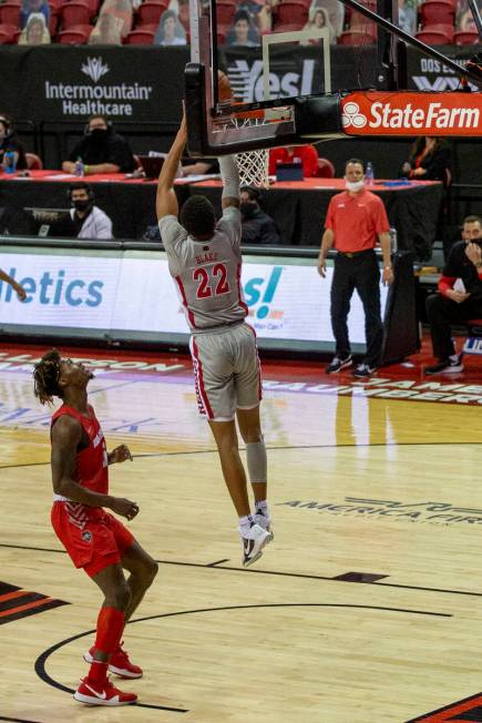 UNLV Rebels guard Nick Blake (22) goes up backwards to dunk the ball in the hoop against New Me ...