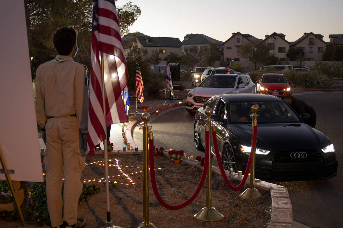 Members of the Jewish community drive through to pay their respects to Sheldon Adelson by light ...