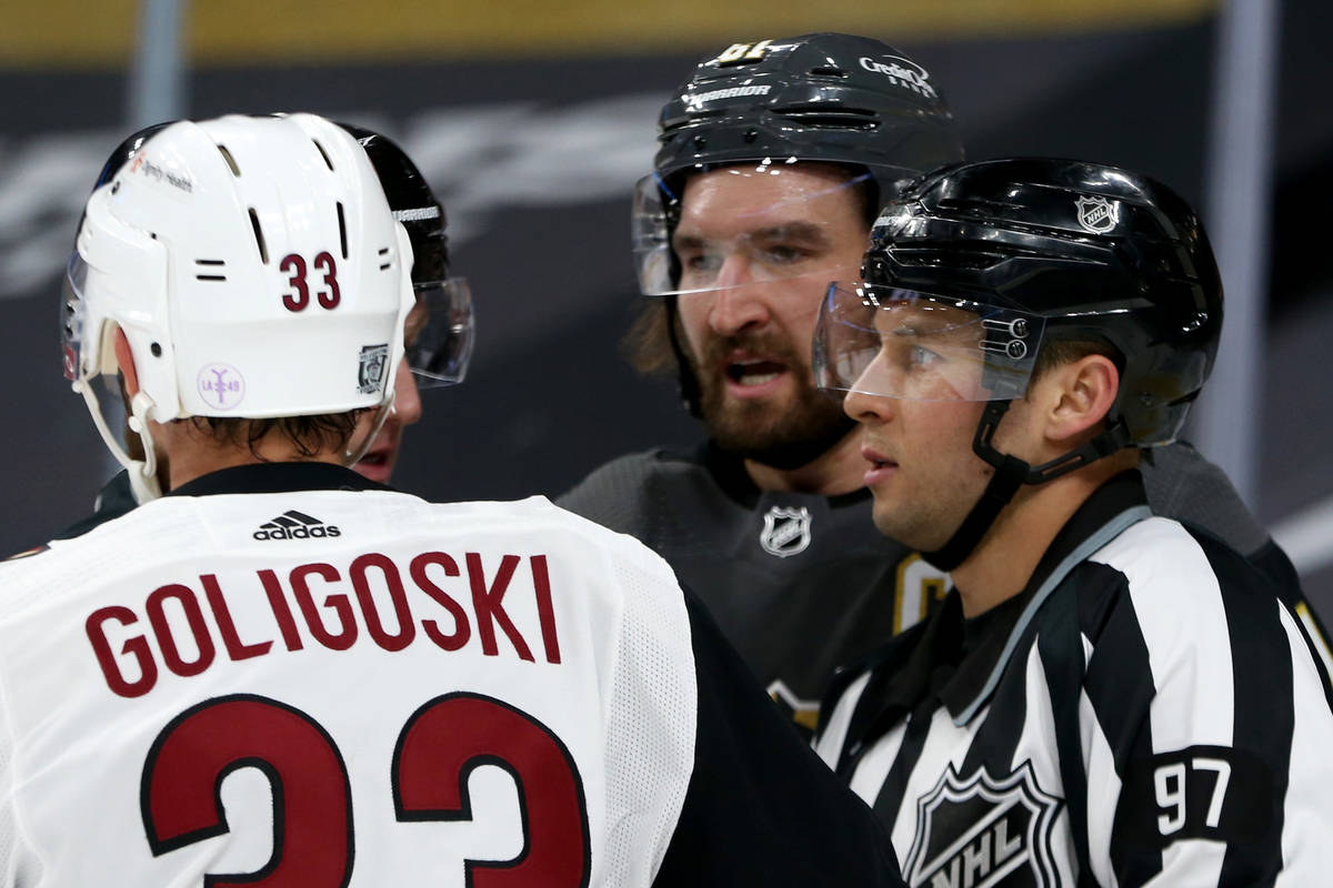 Golden Knights' right wing Mark Stone (61) has a fight with Arizona Coyotes' defenseman Alex Go ...