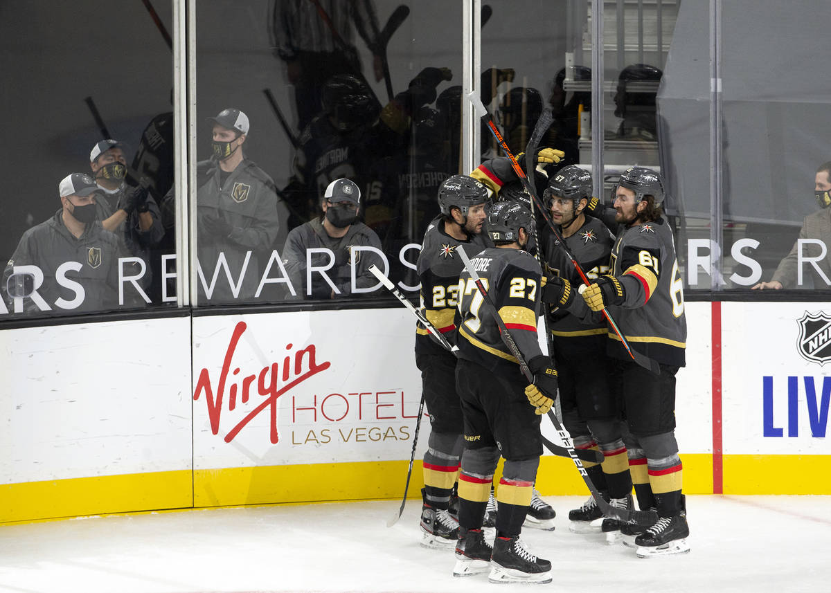 Golden Knights' members celebrate after left wing Max Pacioretty (67) scored a goal against the ...