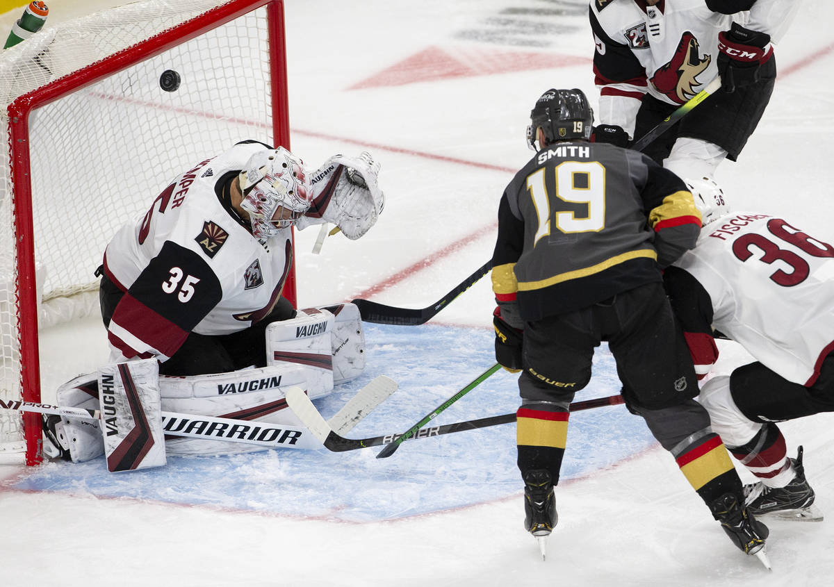 Golden Knights' right wing Reilly Smith (19) scores a goal as Arizona Coyotes' goaltender Darcy ...