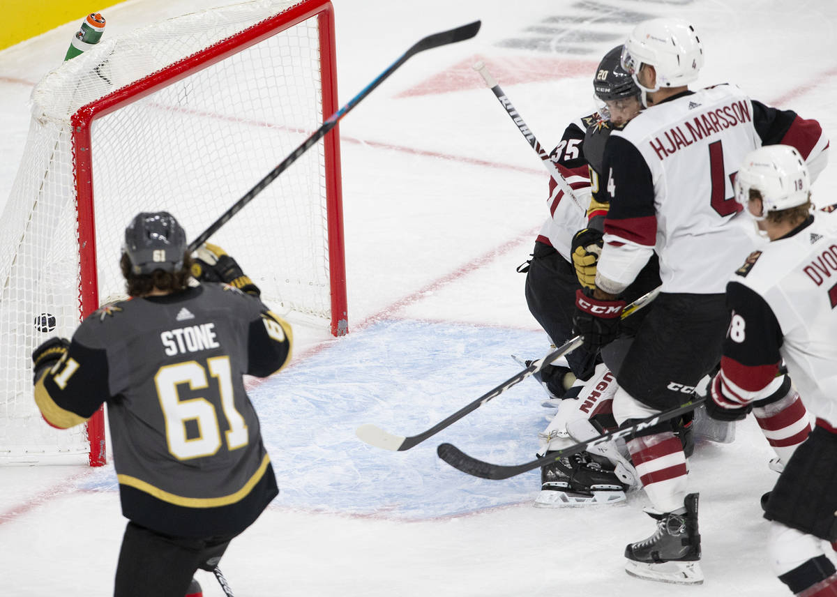 Golden Knights' center Chandler Stephenson (20) scores a goal against the Arizona Coyotes durin ...
