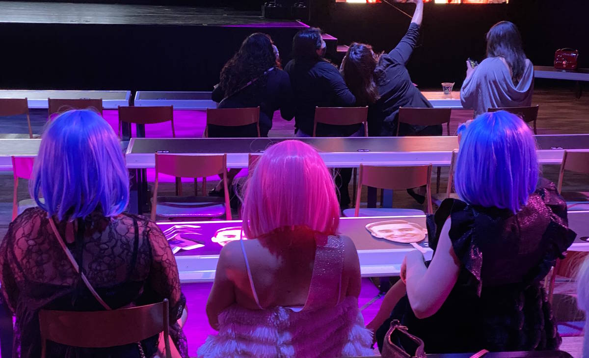 A trio of audience members sport fluorescent wigs during a return of Thunder From Down Under at ...