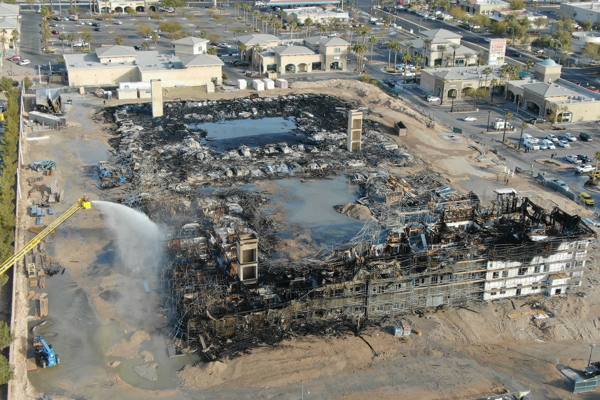 An aerial view of the damage after an overnight fire at an under-construction apartment complex ...
