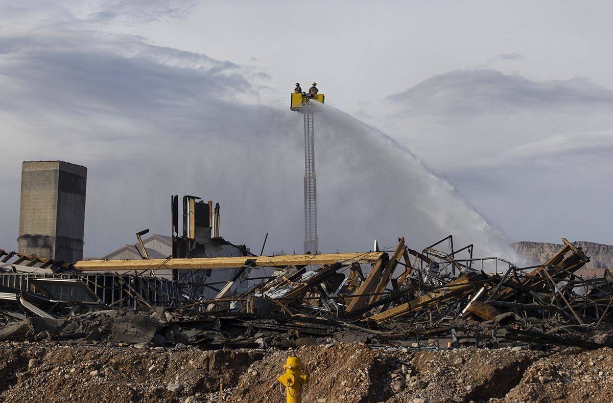 Clark County firefighters spray water at an under-construction Ely at Fort Apache apartment com ...