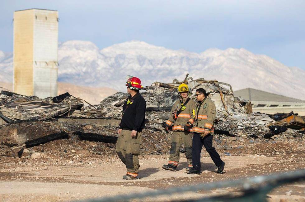 Clark County firefighters survey the damage done by fire to an under-construction Ely at Fort A ...