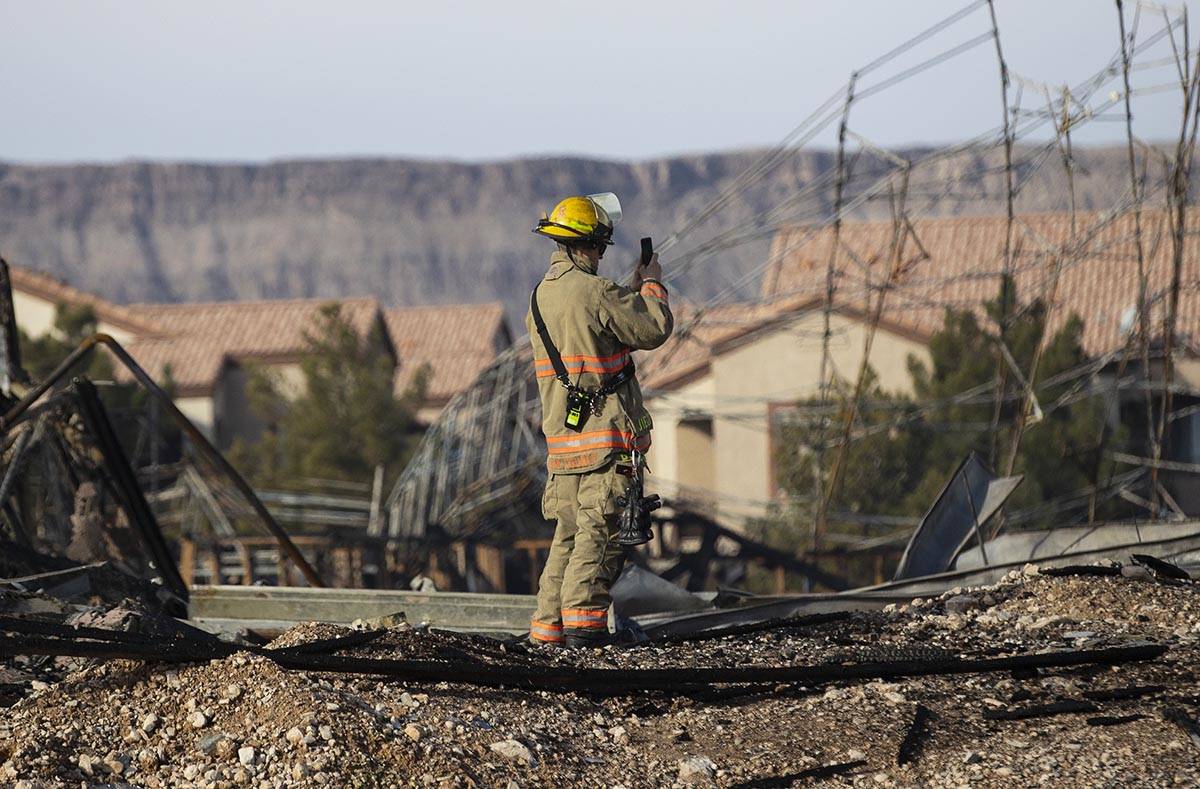 A Clark County firefighter surveys the damage done by fire to an under-construction Ely at Fort ...