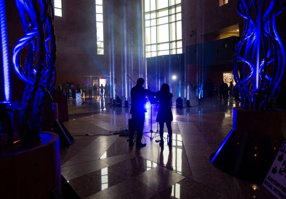 Violinists Dmytro Nehrych, left, and Wonyoung Na perform as 29 lights illuminate the rotunda at ...
