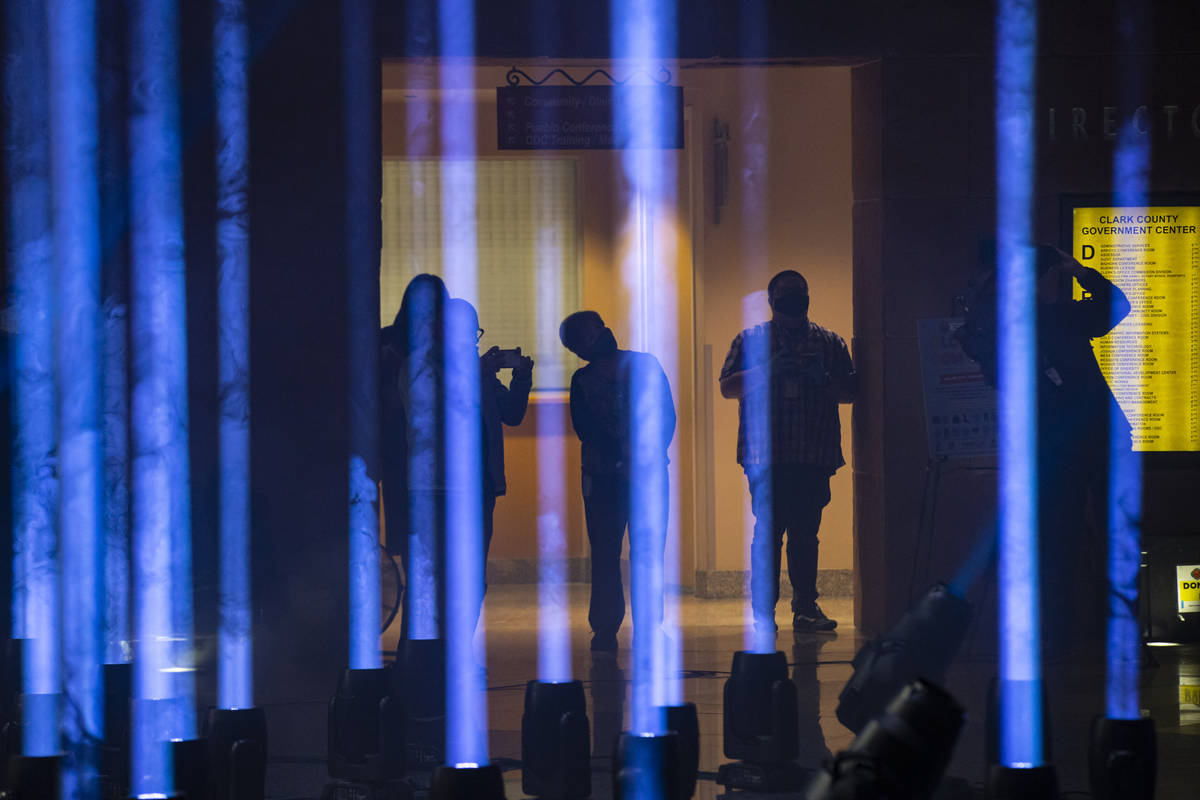 People record with their phones as 29 illuminate the rotunda at the Clark County Government Cen ...