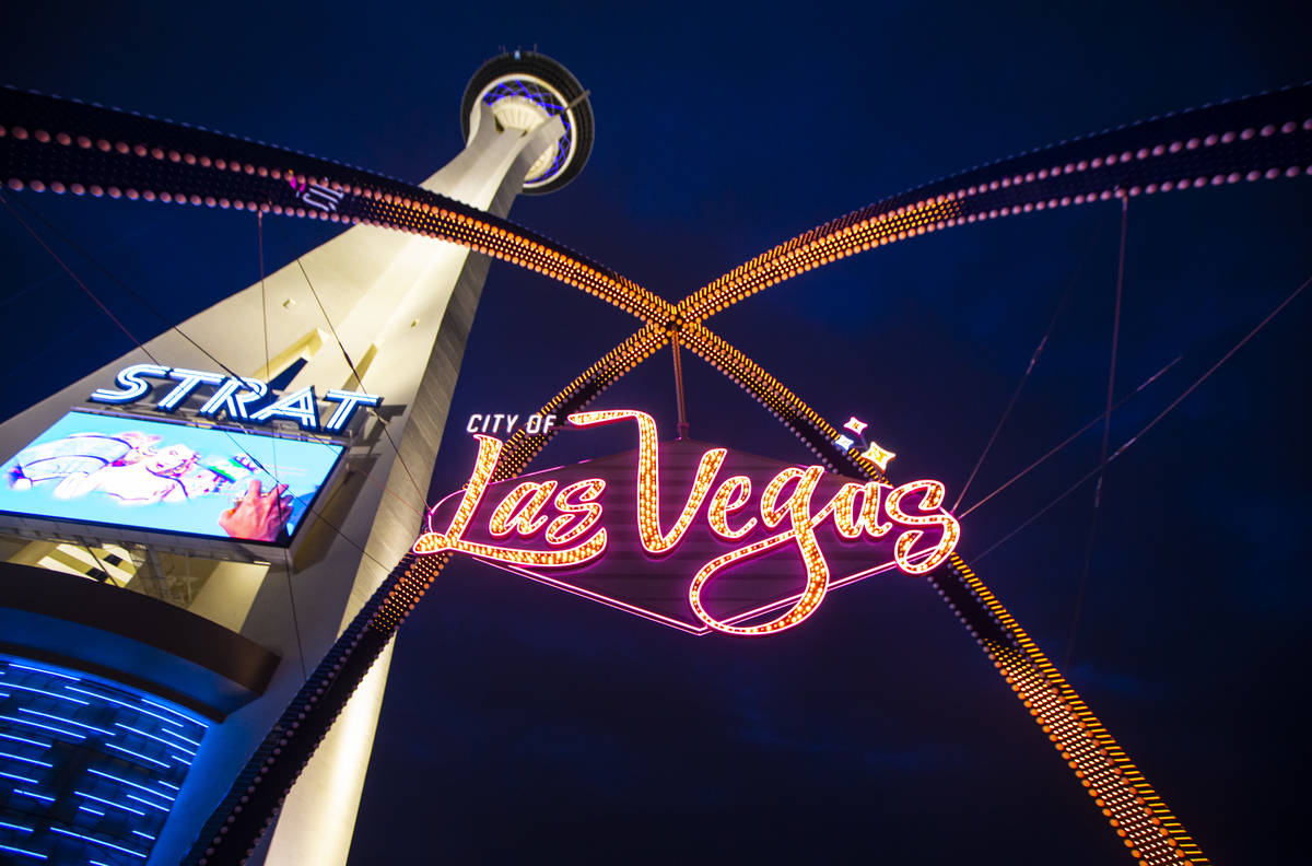 Amber lights illuminate the gateway arches in downtown Las Vegas as part of a remembrance for v ...