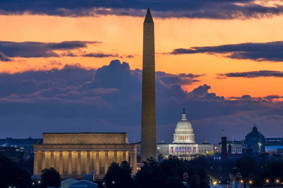 Dawn breaks behind the Lincoln Memorial, Washington Monument, and the U.S. Capitol on Inaugurat ...