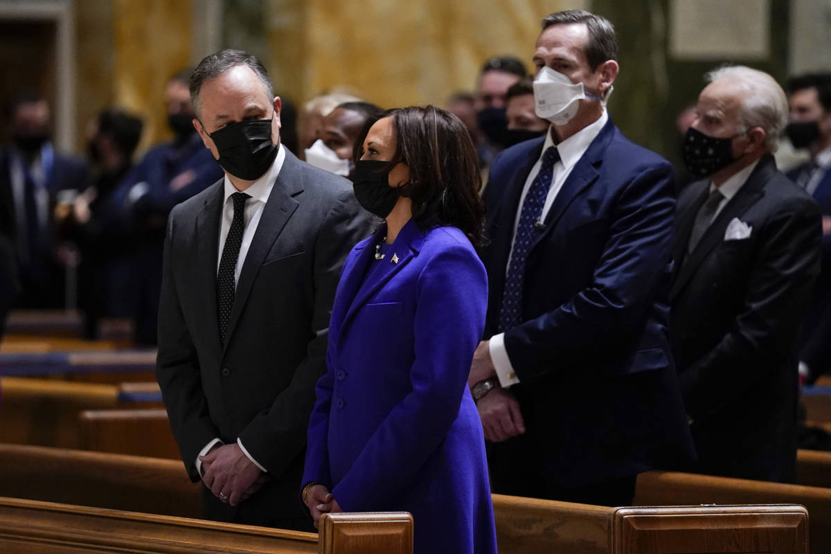 Doug Emhoff looks at his wife Vice President-elect Kamala Harris as they attend Mass at the Cat ...