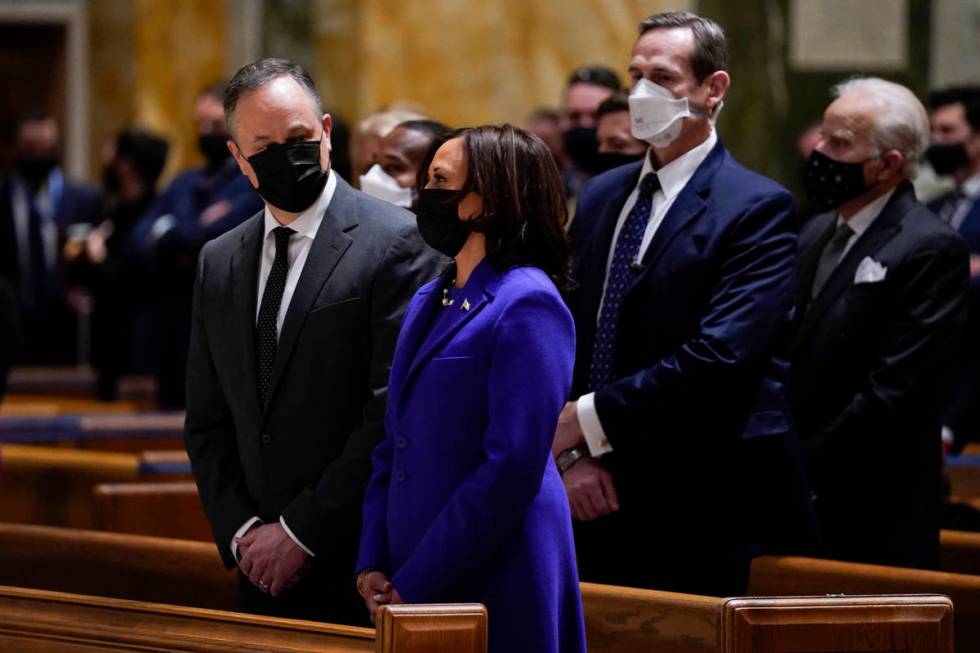 Doug Emhoff looks at his wife Vice President-elect Kamala Harris as they attend Mass at the Cat ...
