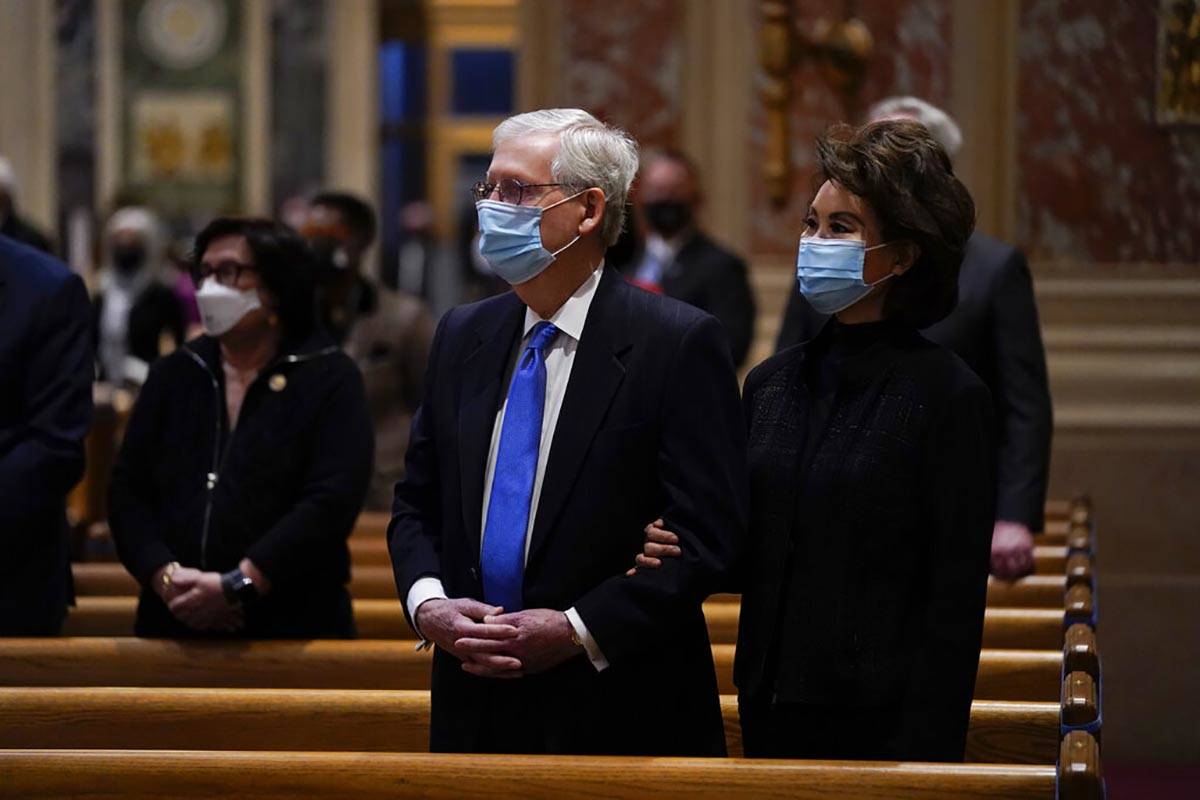 Senate Minority Leader Mitch McConnell and his wife, Elaine Chao, attend Mass at the Cathedral ...