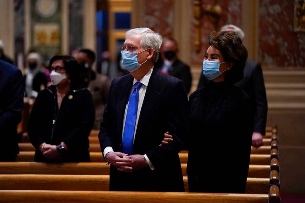 Senate Minority Leader Mitch McConnell and his wife, Elaine Chao, attend Mass at the Cathedral ...