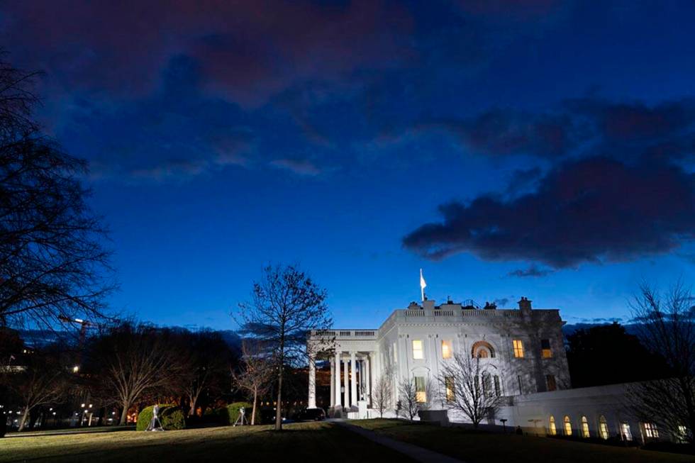 The sun rises behind the White House at dawn, Wednesday, Jan. 20, 2021, in Washington. (AP Phot ...