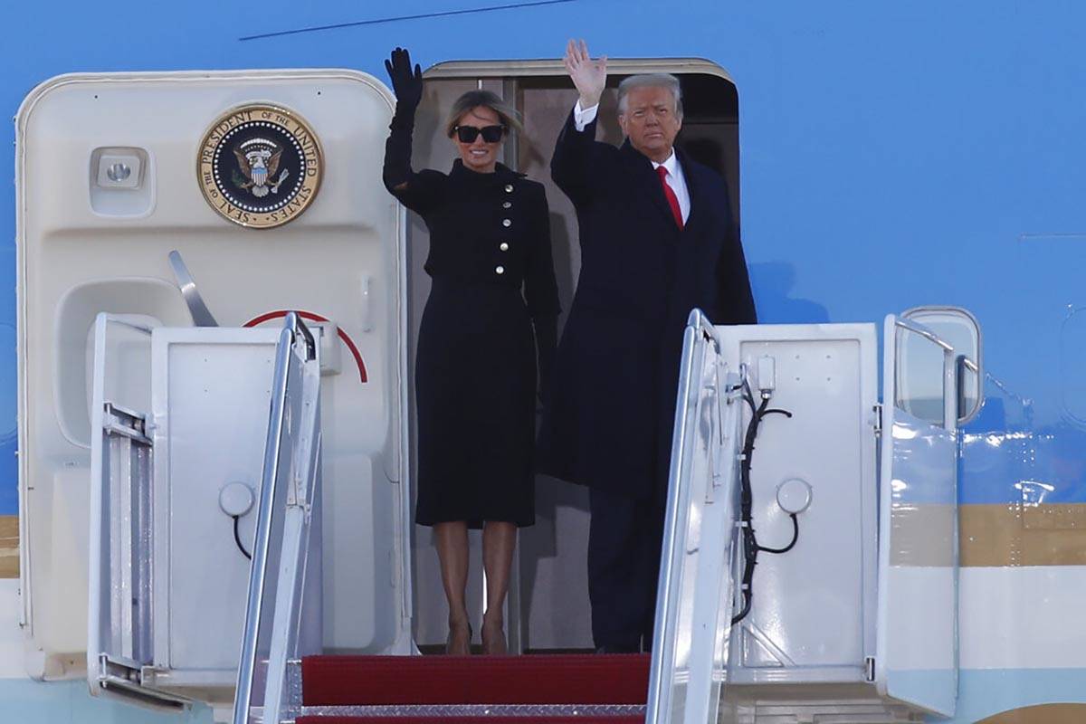 President Donald Trump and first lady Melania Trump wave to a crowd as they board Air Force One ...