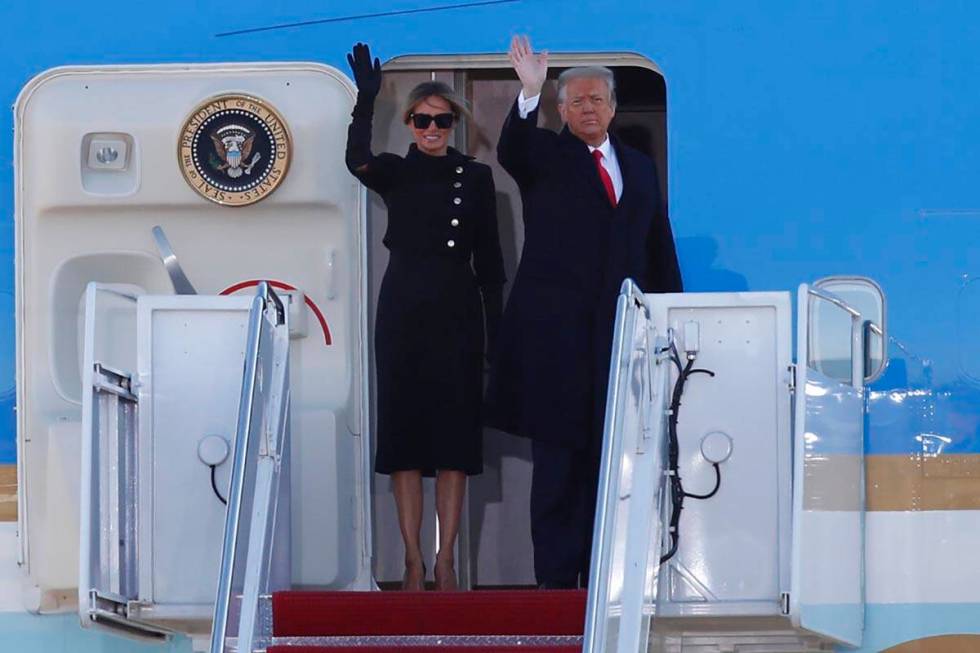 President Donald Trump and first lady Melania Trump wave to a crowd as they board Air Force One ...