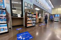 Floor stickers with COVID-19 vaccination information at Smith’s at Flamingo and Sandhill ...