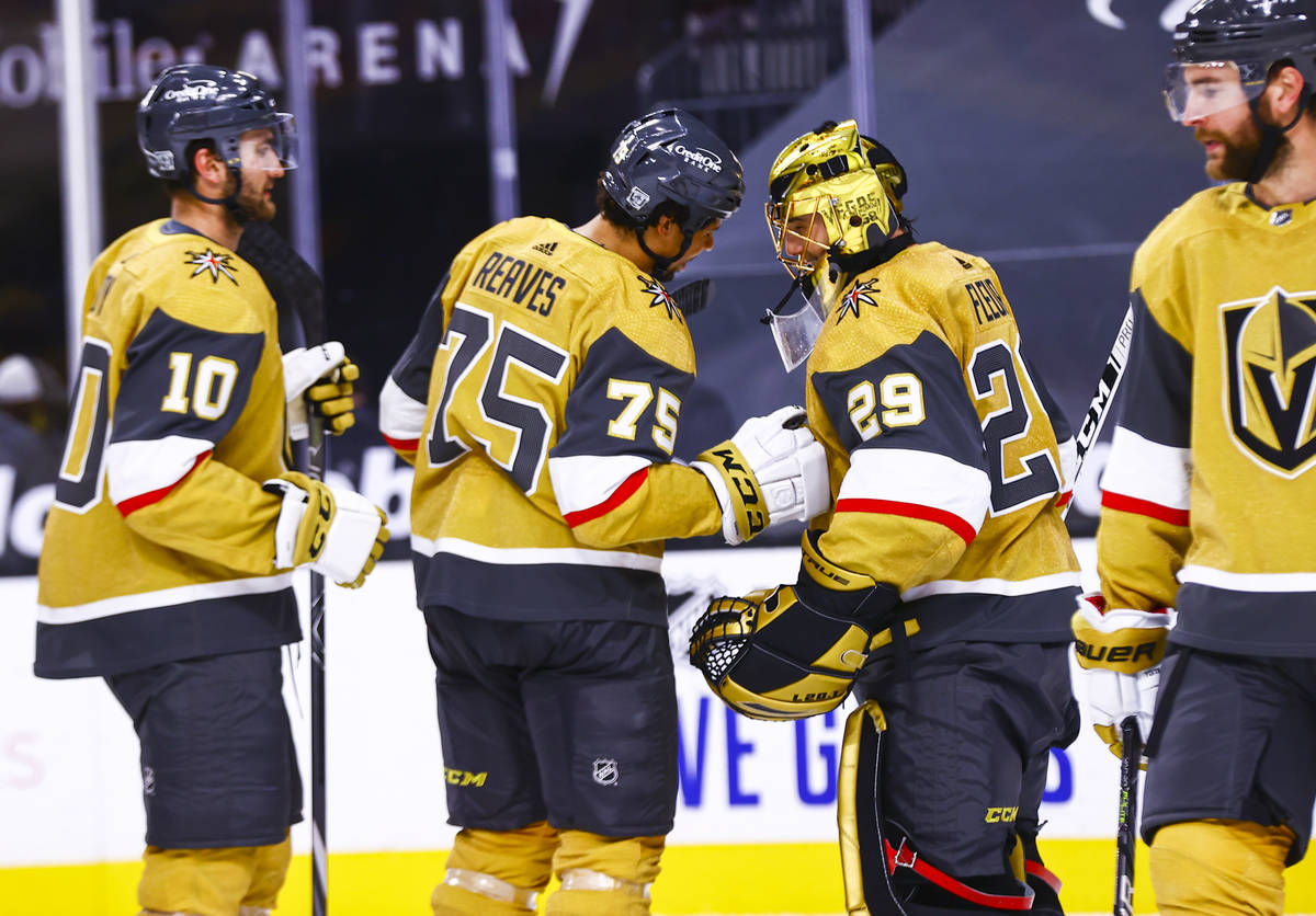 Golden Knights right wing Ryan Reaves (75) celebrates with goaltender Marc-Andre Fleury (29) af ...