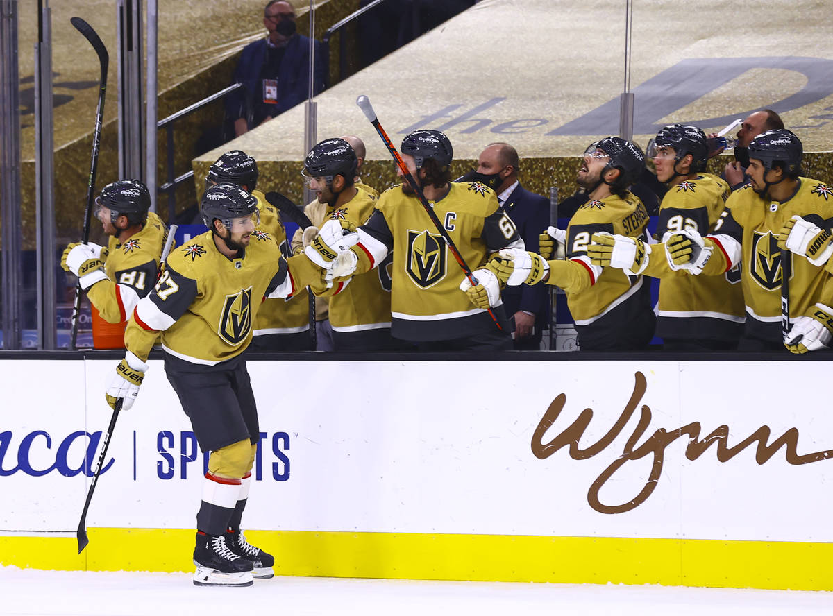 Golden Knights defenseman Shea Theodore (27) celebrates his goal with teammates during the firs ...