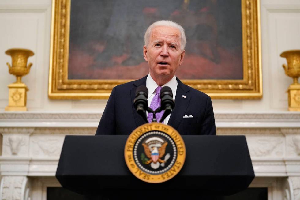 President Joe Biden speaks about the coronavirus in the State Dinning Room of the White House, ...