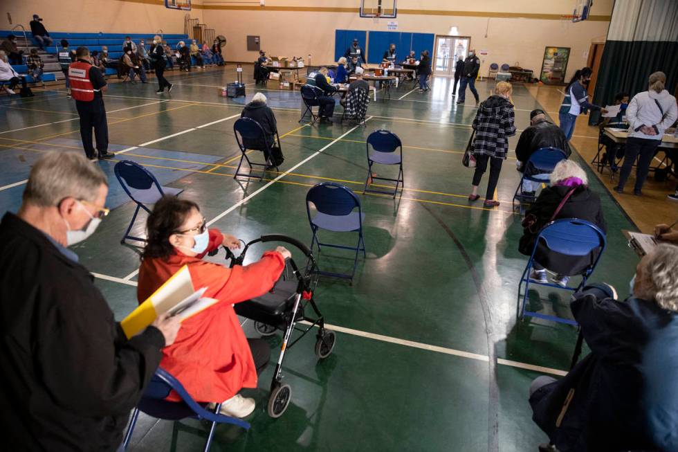 People wait to receive the COVID-19 vaccine at the Neighborhood Recreation Center in North Las ...