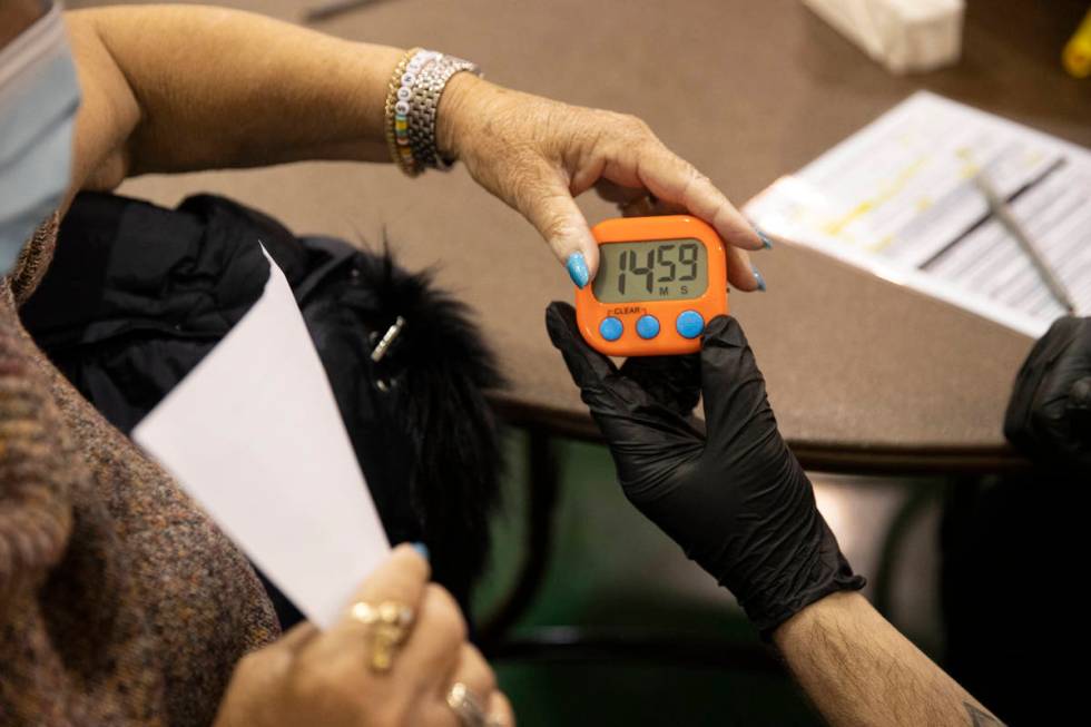 Lynne Lober, 70, receives a 15-minute timer after receiving the COVID-19 vaccine from Nathan Va ...
