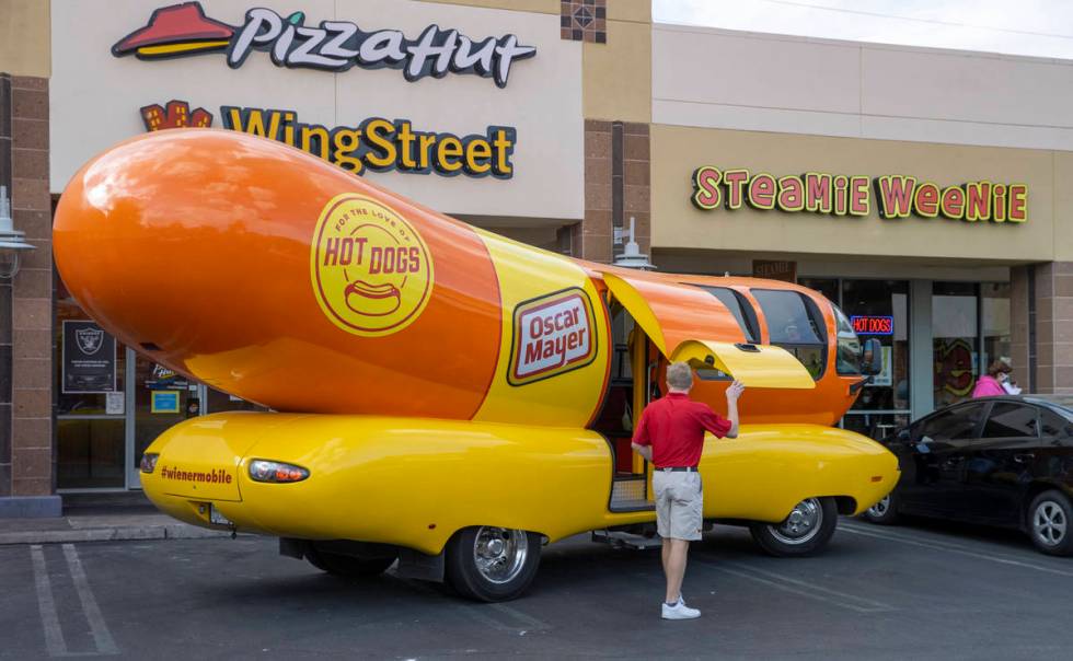 Tommy Salami exits the Oscar Mayer Wienermobile parked outside the Steamie Weenie on Friday, Ja ...