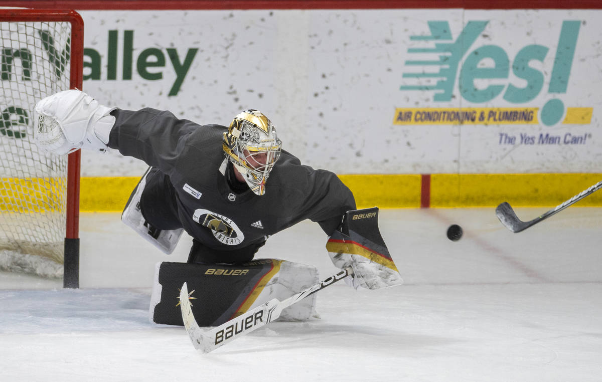 Golden Knights goaltender Logan Thompson (36) makes an acrobatic save during practice at City N ...