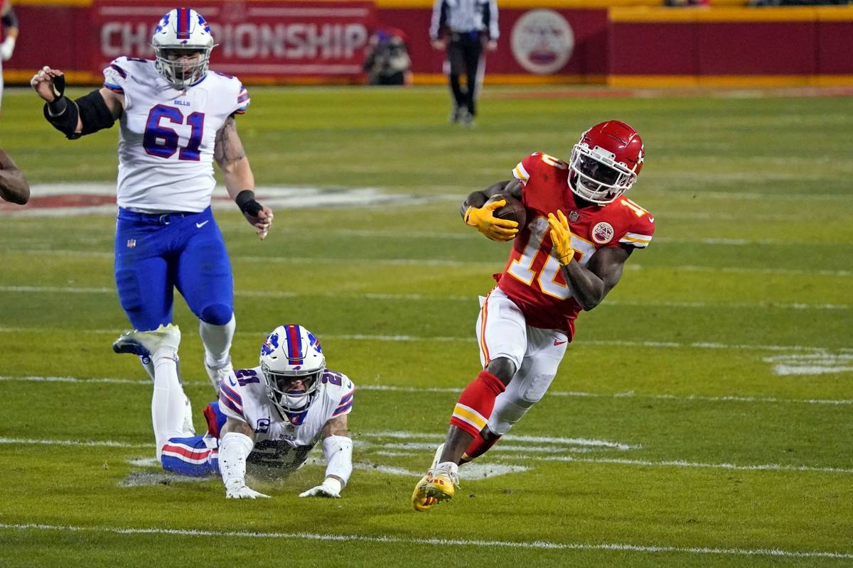 Kansas City Chiefs wide receiver Tyreek Hill (10) runs from Buffalo Bills safety Jordan Poyer ( ...