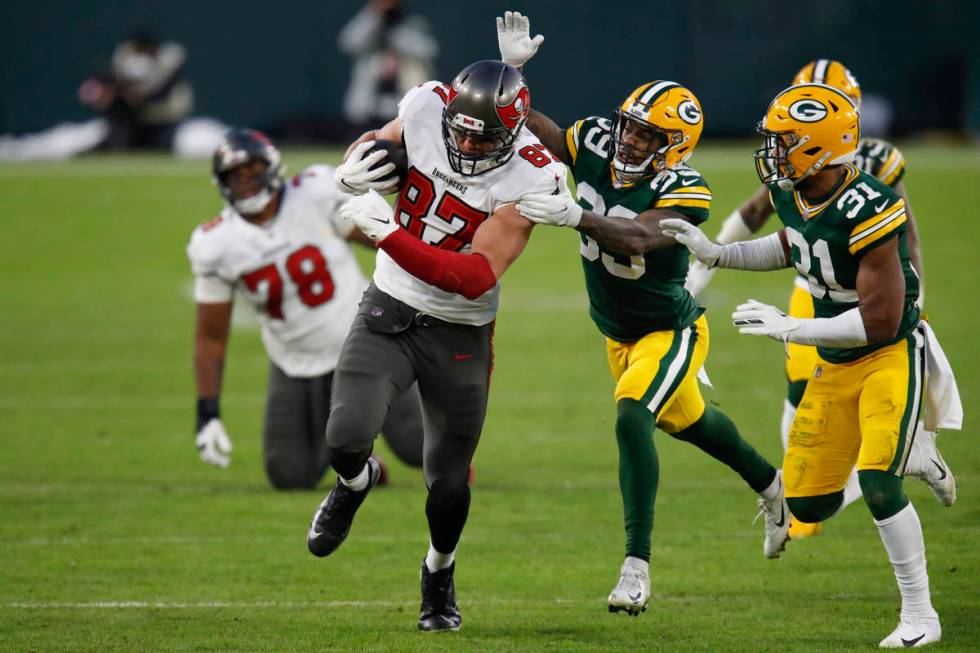 Green Bay Packers' Ka'dar Hollman (29) and Adrian Amos try to stop Tampa Bay Buccaneers' Rob Gr ...