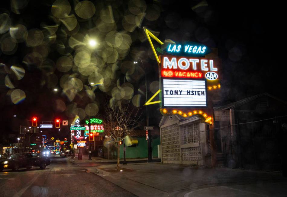 The restored Las Vegas Motel sign is seen through raindrops on Fremont Street in downtown Las V ...