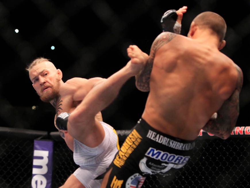 Conor McGregor throws a kick at Dustin Poirier during their fight at UFC 178 Saturday, Sept. 27 ...