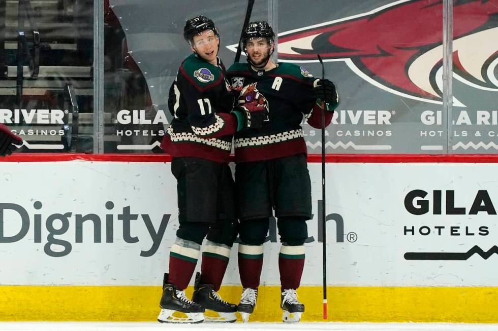 Arizona Coyotes center Derick Brassard, right, celebrates his goal against the Vegas Golden Kni ...