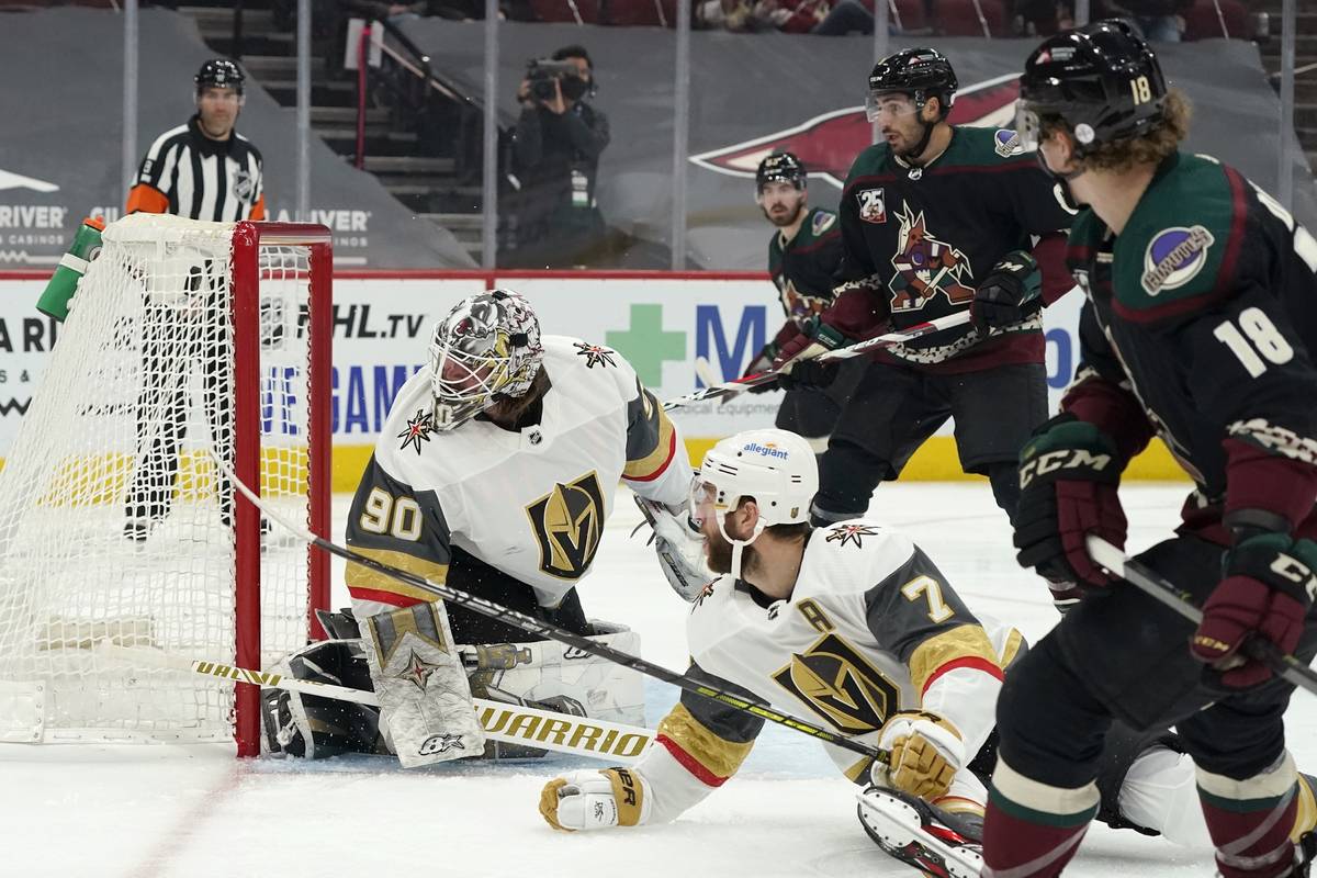 Arizona Coyotes center Christian Dvorak (18) scores a goal against Vegas Golden Knights goalten ...