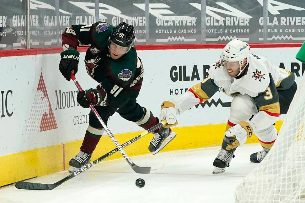 Arizona Coyotes center Drake Caggiula (91) passes the puck in front of Vegas Golden Knights def ...