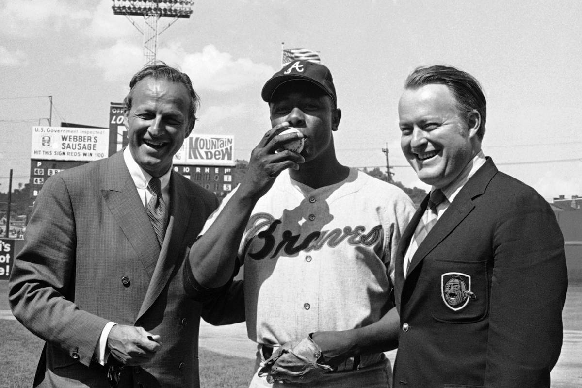 FILE- In this May 17, 1970, file photo Atlanta Braves' Hank Aaron, center, poses for photos aft ...