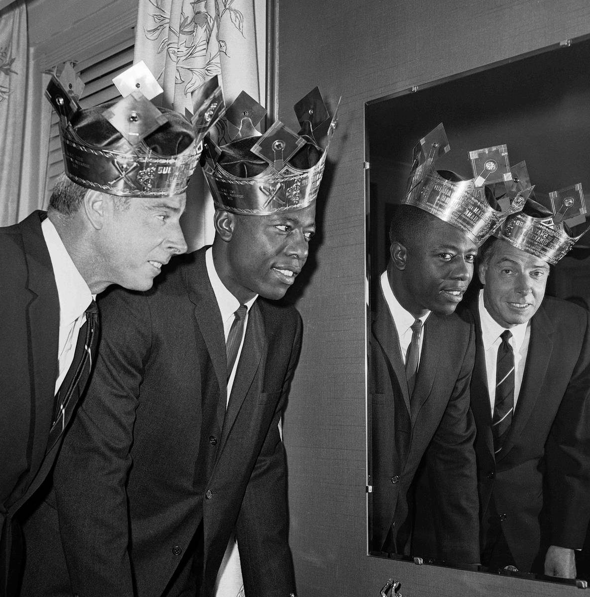Joe DiMaggio and Hank Aaron, wearing their Sultan of Swat crowns at rakish angles, pose with th ...