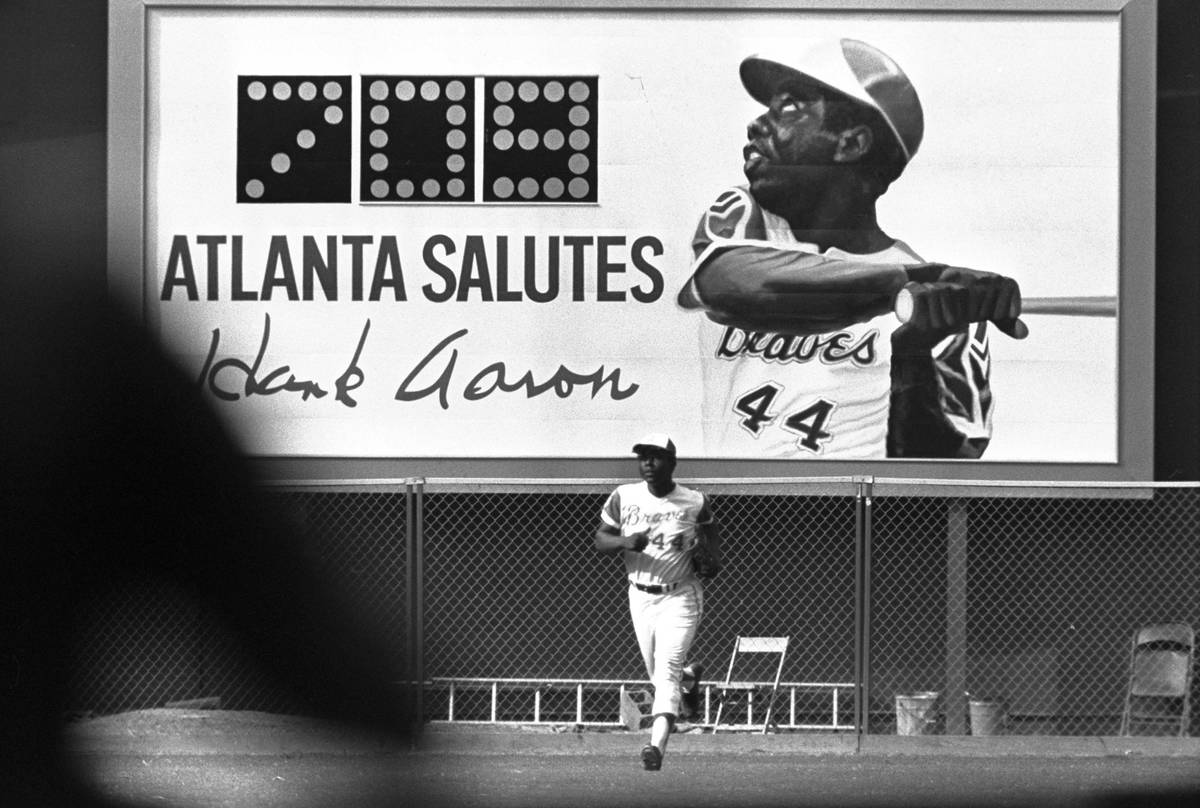 A new sign showing the number of Hank Aaron's home runs provides a background as he runs off th ...