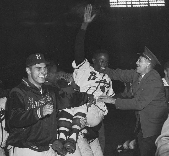Milwaukee Braves' Hank Aaron is carried from the baseball field Sept. 23, 1957, by teammates af ...