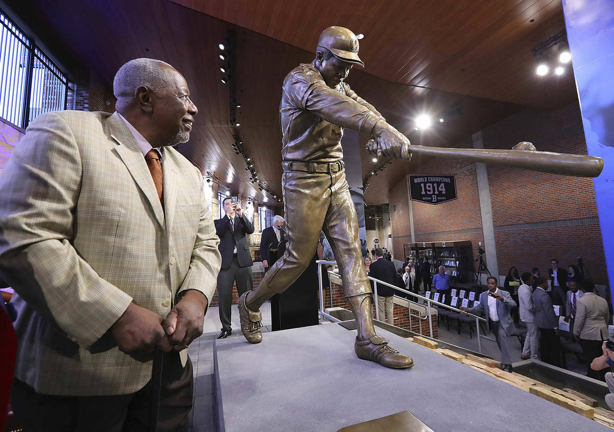 FILE- In this March 29, 2017, file photo, Hank Aaron looks at his new statue in Monument Garde ...
